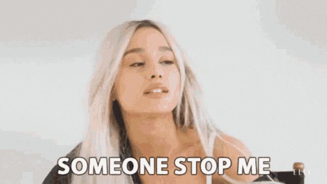 ariana grande is sitting in a chair with her mouth open and someone stop me written on her face .