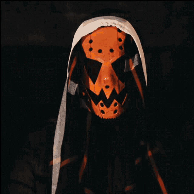 a person wearing an orange mask with a hood