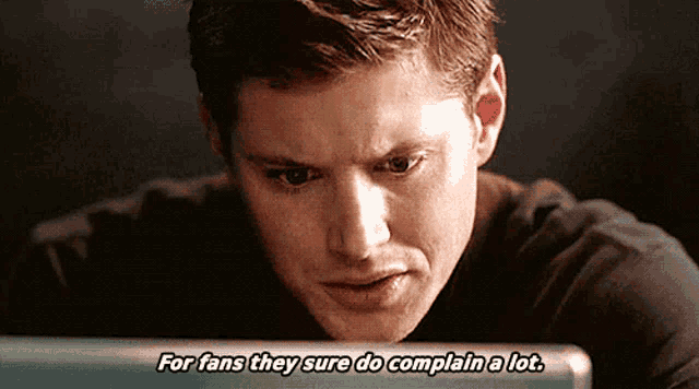 a man is looking at a computer screen and saying for fans they sure do complain a lot