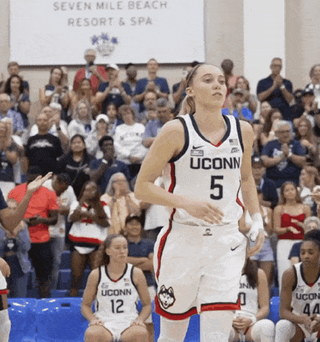 a uconn basketball player stands in front of the crowd