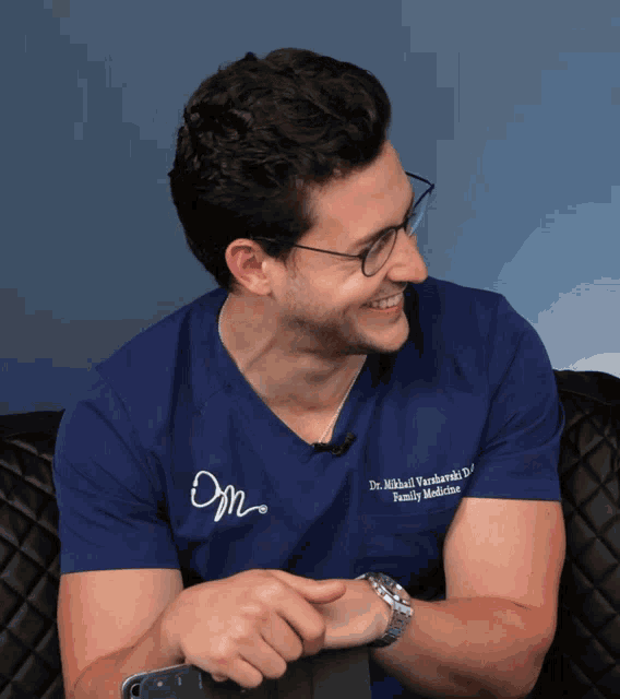 a man wearing glasses and a blue shirt that says dr. michael ivankowski d. family medicine