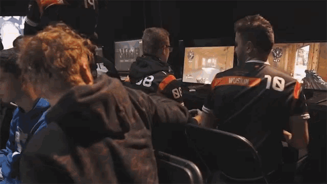 a group of people are playing a video game and one of them has the number 18 on his back