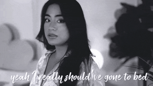 a black and white photo of a woman with the words " yeah i really should 've gone to bed " below her