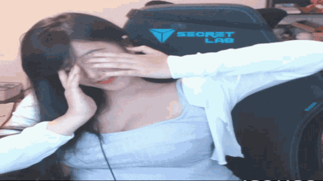 a woman sits in a secret lab chair