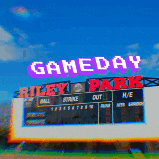 a scoreboard at gameday at riley park with a blue sky in the background