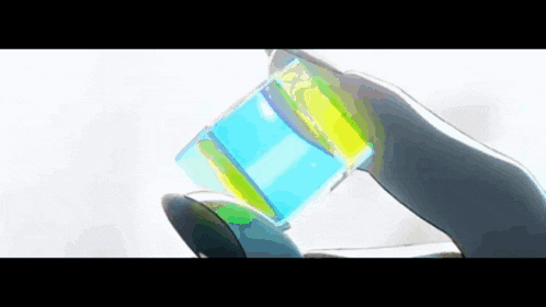 a hand is holding a blue and yellow object