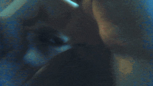 a blurred image of a person 's face and a blue background