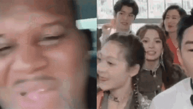 a group of people are standing next to each other and looking at the camera .