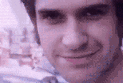 a close up of a man 's face with a purple background .