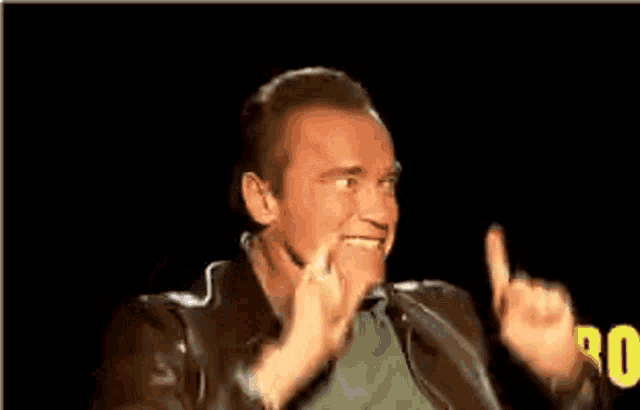 arnold schwarzenegger is making a funny face with his hands in the air and the words tits !