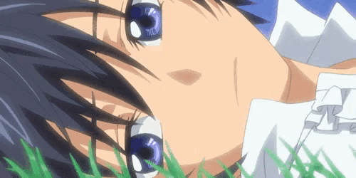 a close up of a person 's face with blue eyes and a white shirt