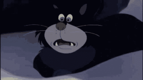 a close up of a cartoon cat with green eyes and a surprised look on his face .