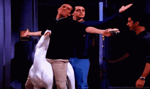 a man is holding a hamburger while another man holds a goose .