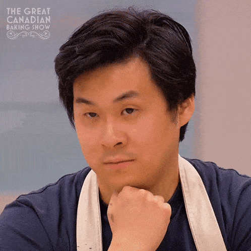the great canadian baking show is shown on the screen of this man