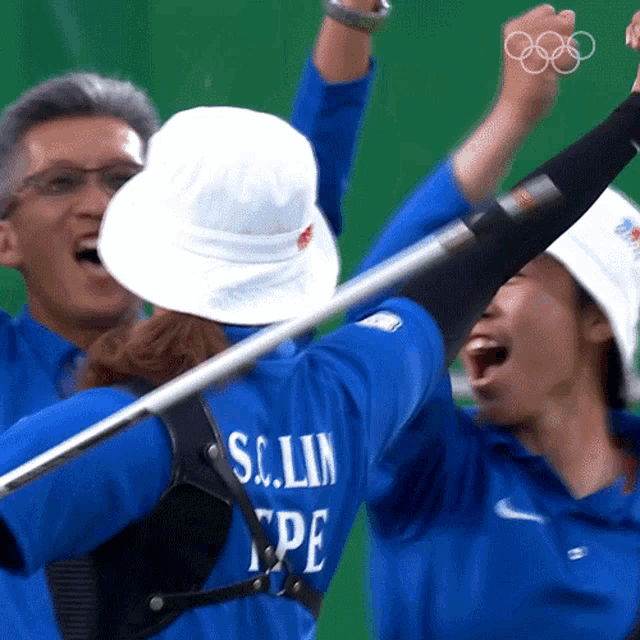 a person wearing a blue shirt that says s.c. lin