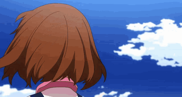 a girl with brown hair is looking up at a blue sky