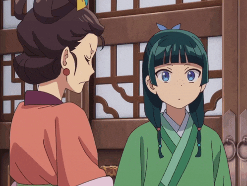 a girl with blue hair is standing next to another girl