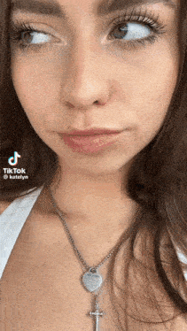 a close up of a woman 's face with a necklace that says forever