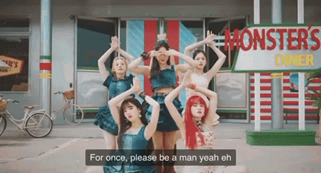 a group of women are dancing in front of a monsters diner sign