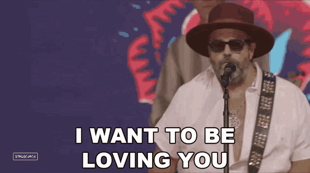 a man singing into a microphone with the words " i want to be loving you " below him