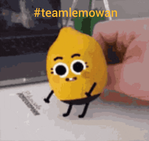 a cartoon lemon with arms and legs is being held by a person