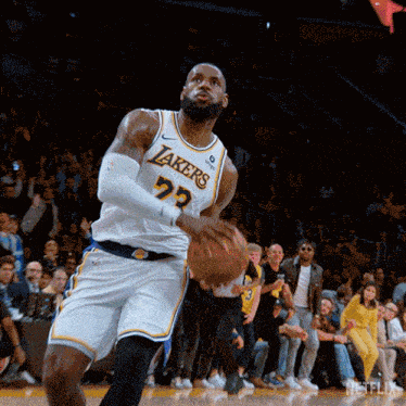 a basketball player with the number 72 on his jersey is holding a basketball