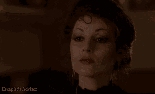 a close up of a woman 's face with the words escapist 's advisor on the bottom