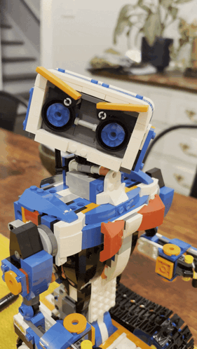 a blue and white robot with a speaker on the head