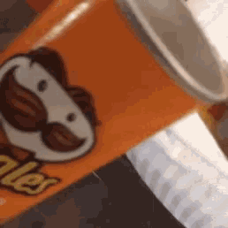 a can of pringles sits next to a bottle of water