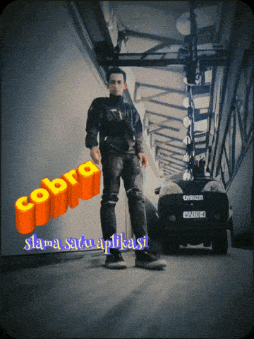 a man standing in a hallway next to a car and the word cobra
