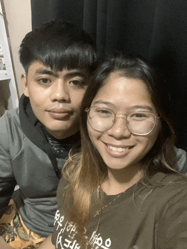 a man and a woman are posing for a picture and the woman is wearing a shirt that says ' free '