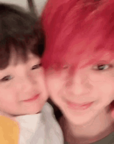 a close up of a person with red hair and a child .