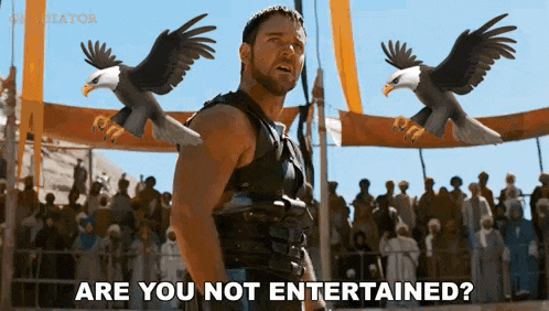 a man is standing in front of two bald eagles with the words " are you not entertained " written below him