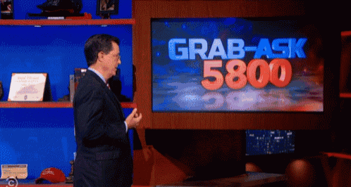 a man is standing in front of a screen that says grab-ask 5800