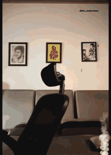 a chair in front of a wall with a picture of a man on it and the words @am_kashidhani on the bottom
