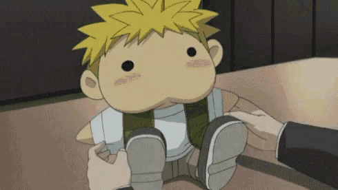 a cartoon character is being held by a person