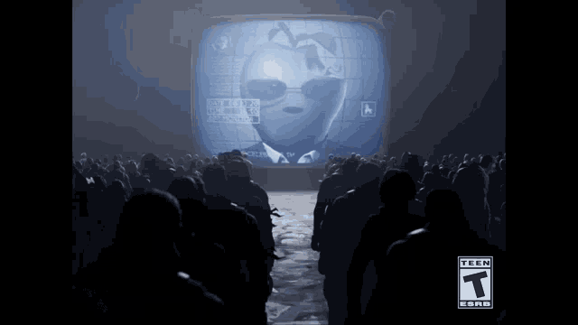 a group of people are standing in front of a tv screen with an apple on it