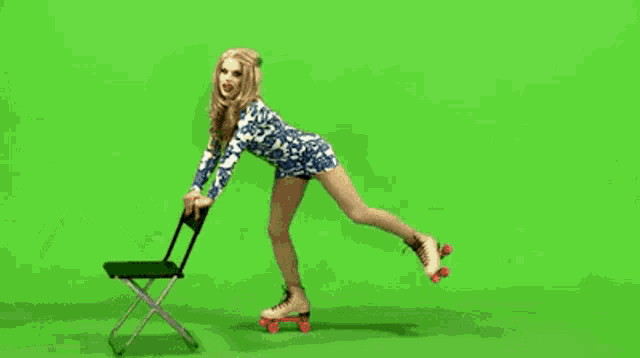a woman is rollerblading on a green screen while sitting on a chair .