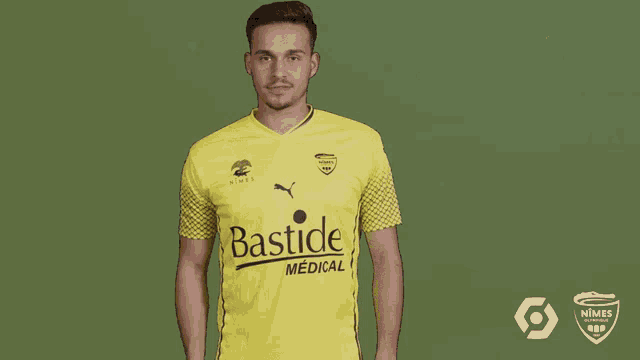 a man is wearing a yellow bastide medical shirt
