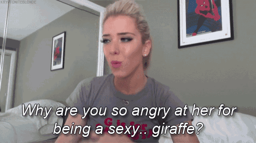 a woman is sitting on a bed and says why are you so angry at her for being a sexy giraffe