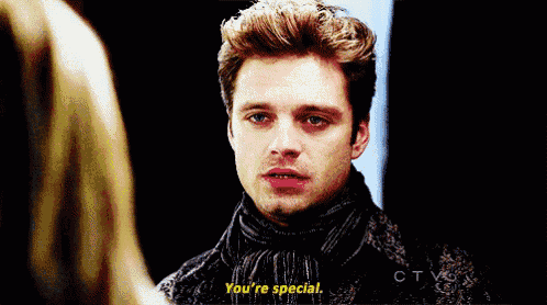 a man with a scarf around his neck is talking to a woman and says " you 're special "