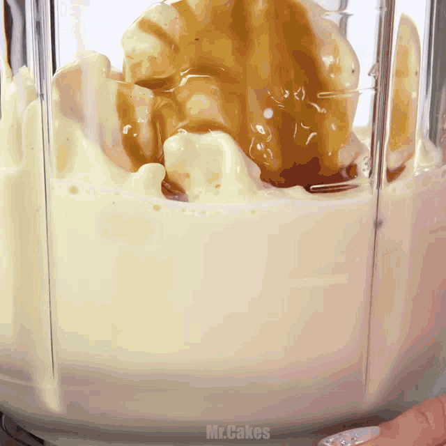 a blender filled with ice cream and caramel sauce with the words mr.cakes above it