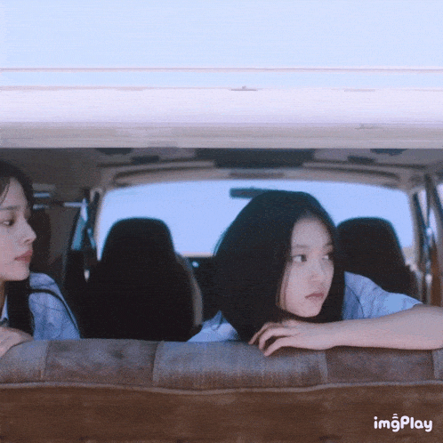 two girls in a car with the word imgplay visible