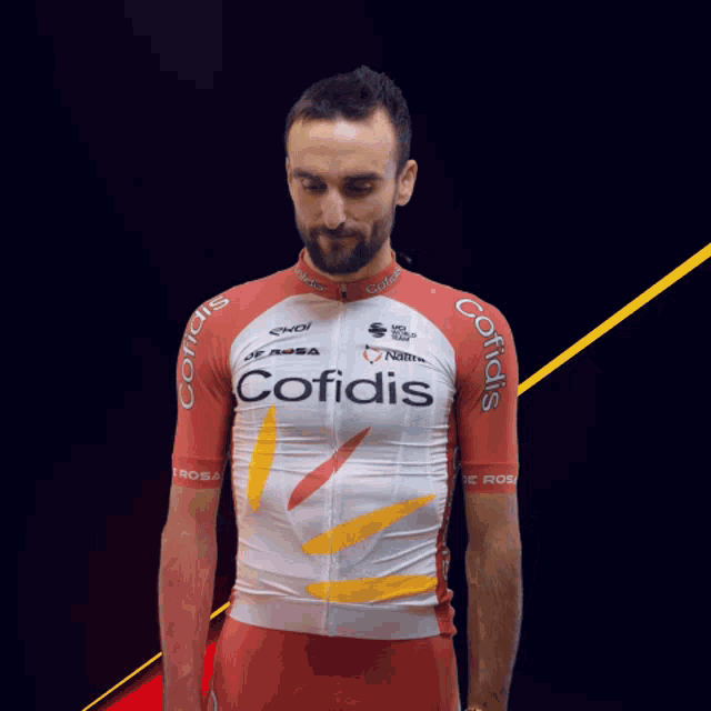 a man wearing a red and white cofidis shirt