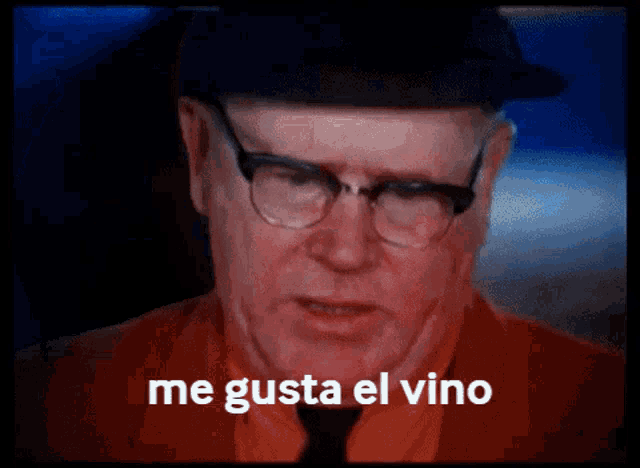 a man wearing glasses and a hat says " me gusta el vino "