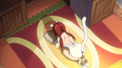 a girl with red hair is laying on the floor with a book