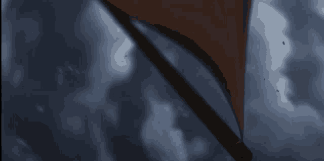 a close up of an umbrella flying in the sky