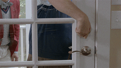 a person is opening a door with a broken glass
