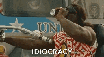 a man is riding a motorcycle and holding a can of soda in his hand .