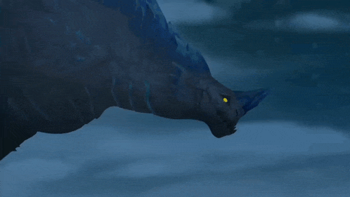 a blue and black dragon with a yellow eye is swimming in the water .